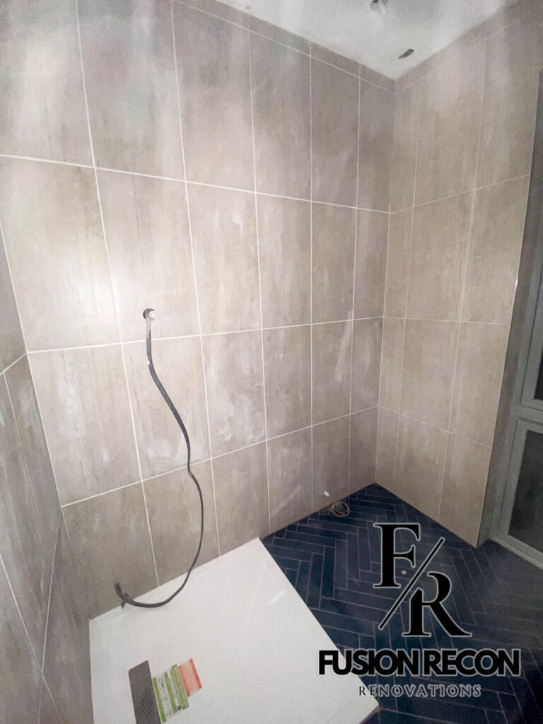 Modern herringbone floor tiles in a luxury bathroom – South Kensington SW7