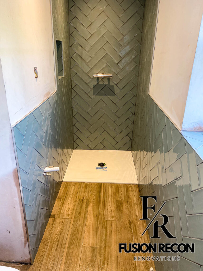Compact bathroom design with wood-effect floor and walk-in shower – Fulham SW6