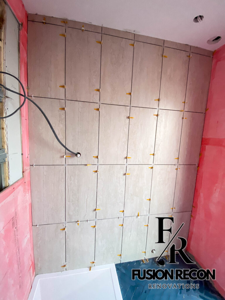 Modern herringbone floor tiles in a luxury bathroom – South Kensington SW7