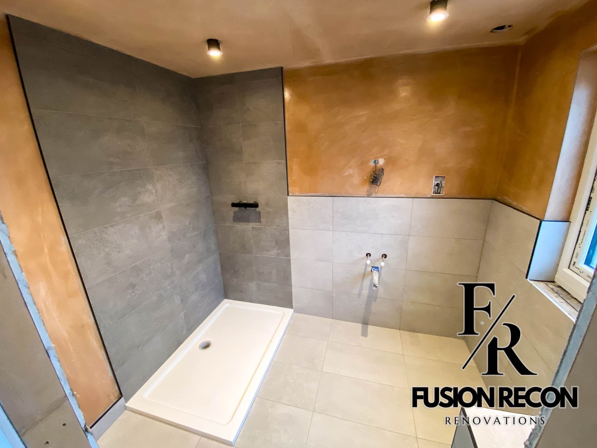 Sleek grey bathroom design with walk-in shower and black fixtures – Wimbledon SW19