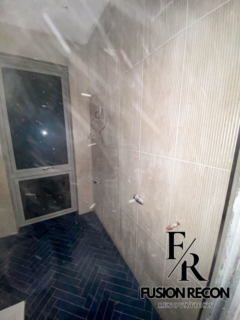 Small herringbone tiles in a premium bathroom renovation – South Kensington SW7