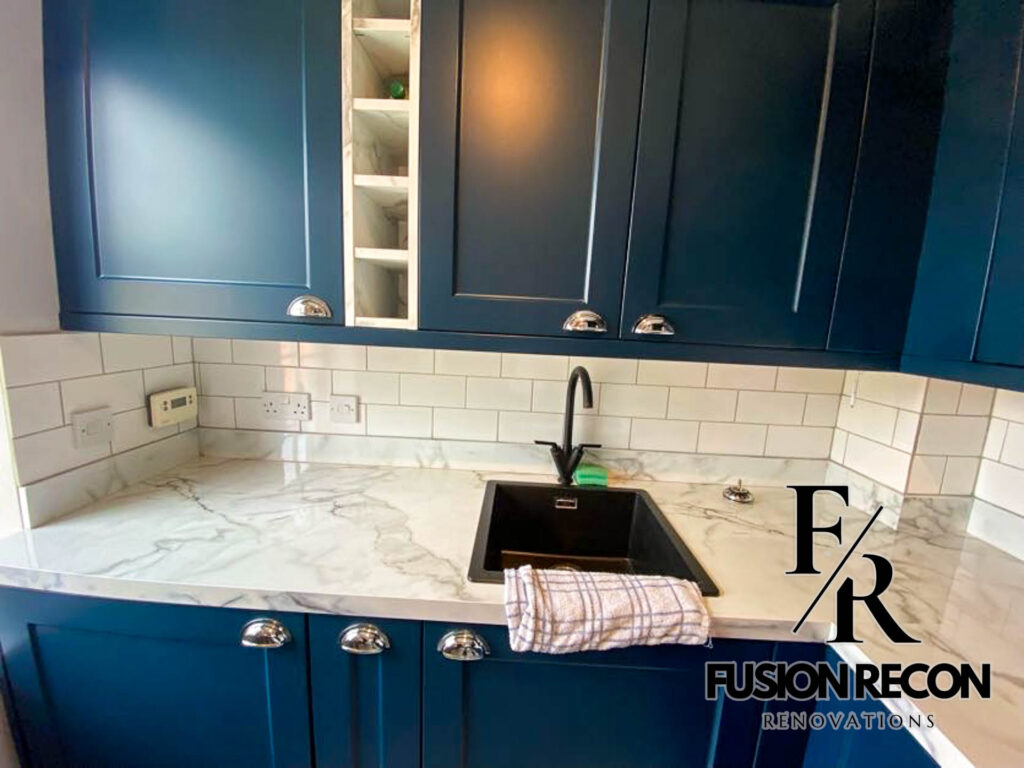Kitchen splashback tiles with navy blue cabinetry and white quartz worktop – Putney SW15