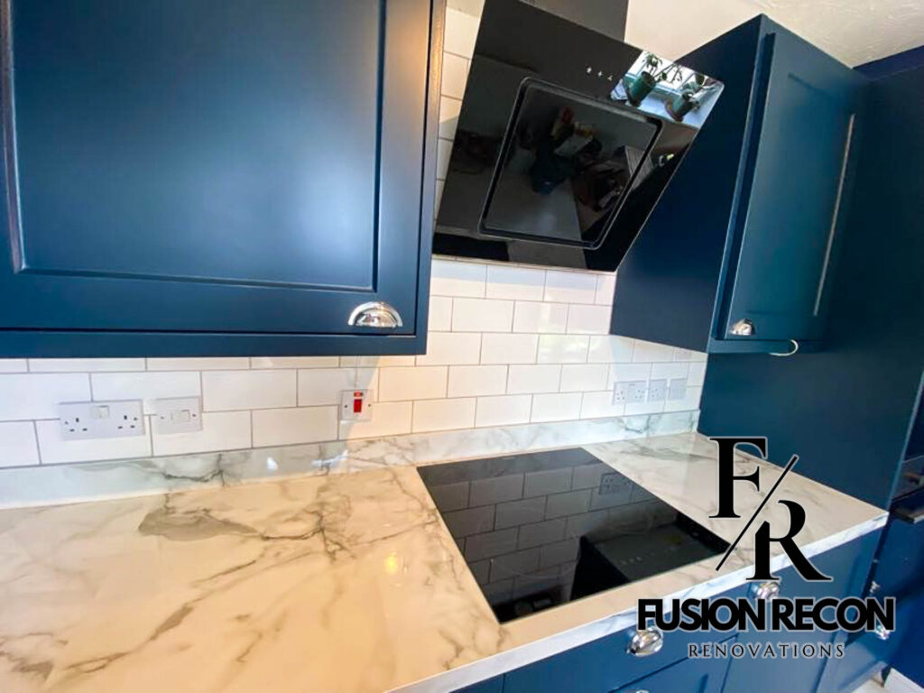 Stylish navy blue kitchen with brass handles and quartz countertop – Putney SW15